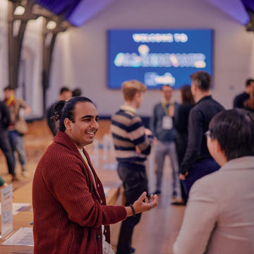 Two people talking animatedly during an All-Innovate bootcamp